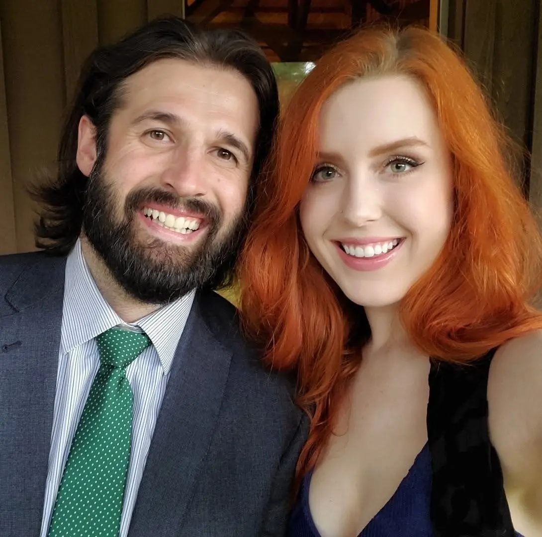 Mitch in a suit and green tie with Brittany, both smiling