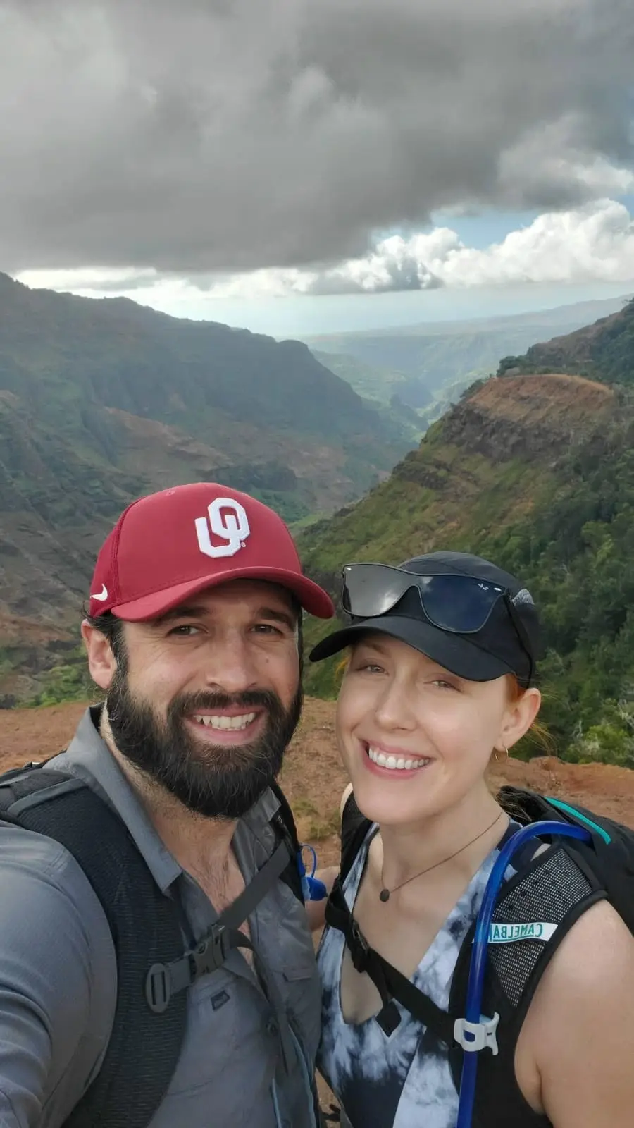 Hiking selfie of Mitch in an OU cap and Brittany at a canyon overlook