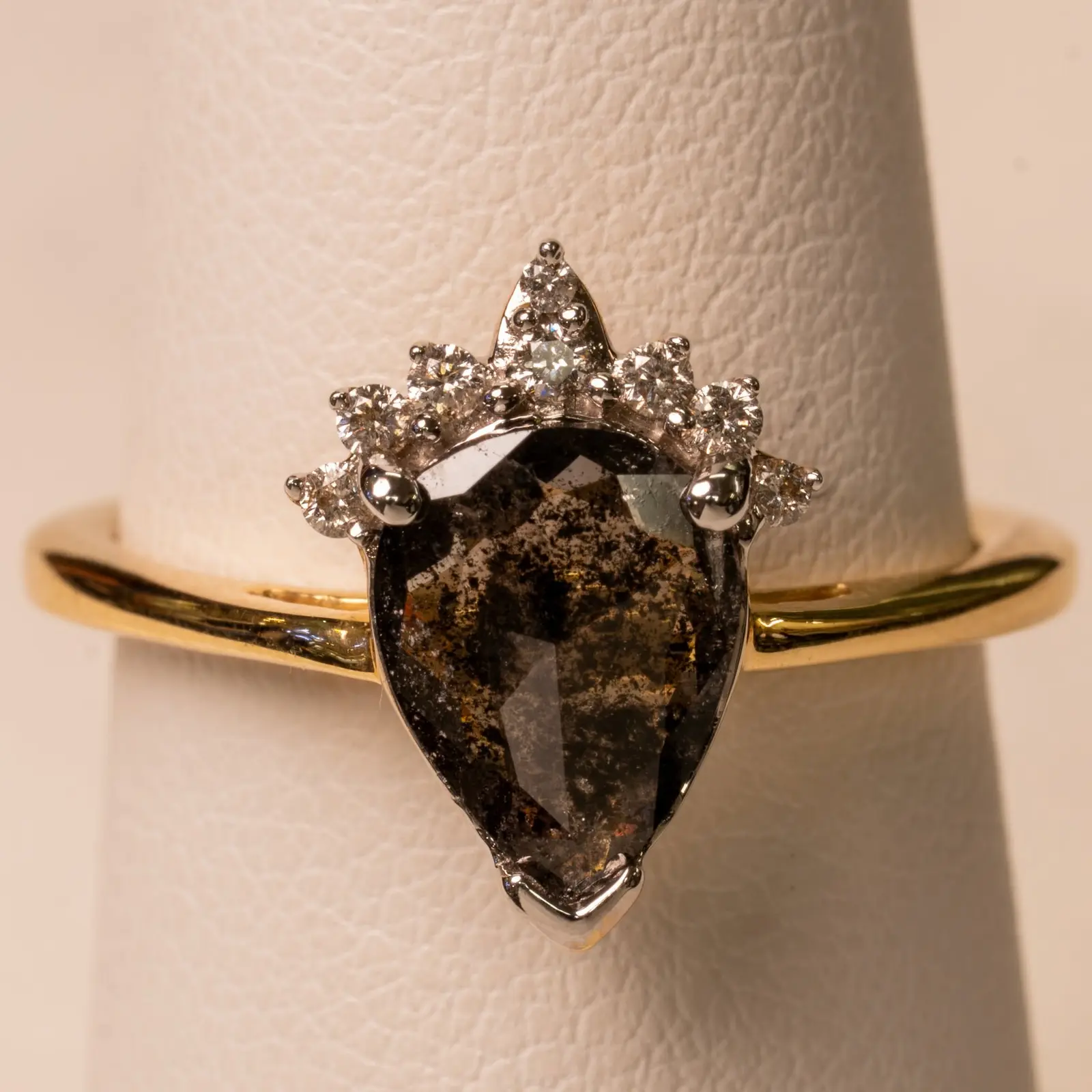 Close-up product photo of a salt and pepper pear diamond crown ring in yellow gold, made for The Diamond Shop